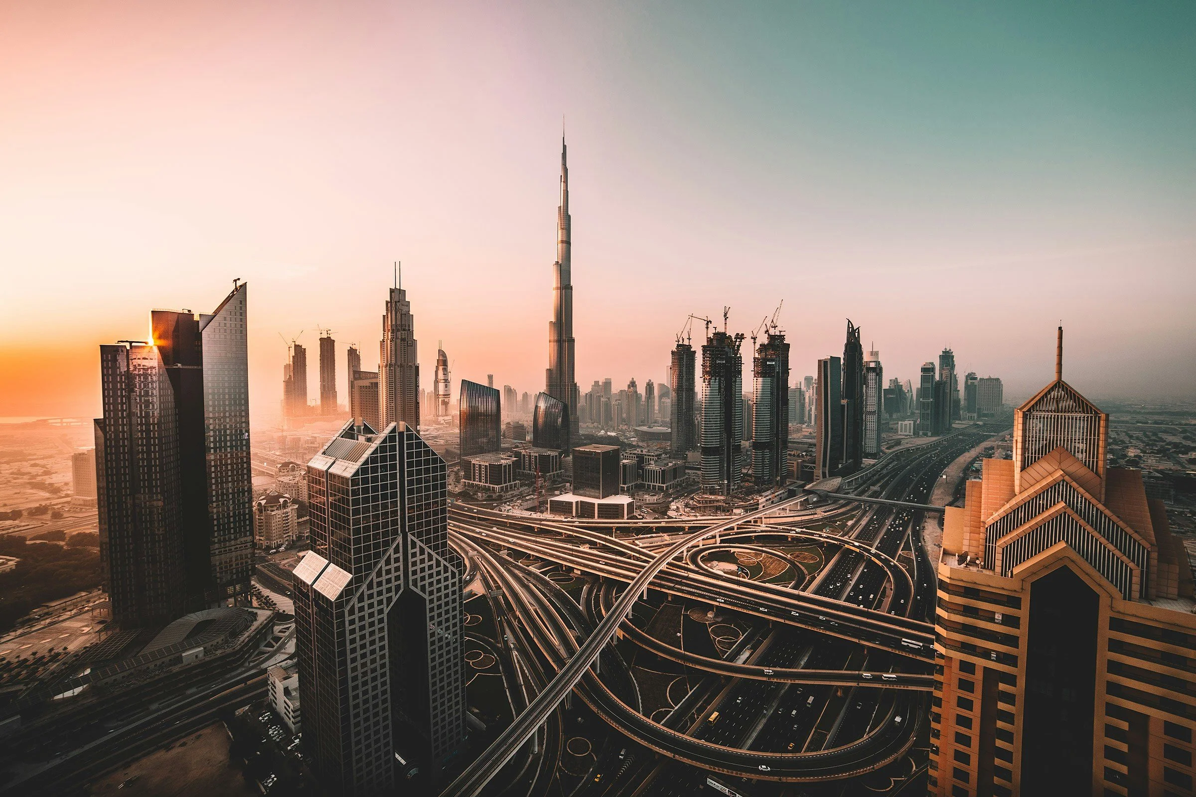 Burj Khalifa rising above the Downtown Dubai skyline at sunset